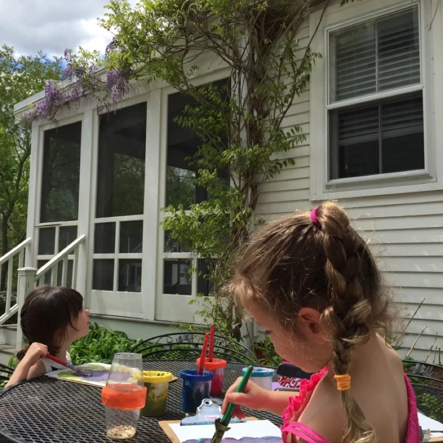 Children painting outdoors at Blue River Montessori school
