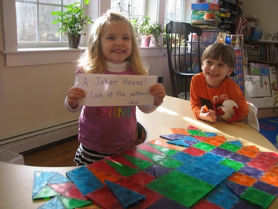 Children working with Montessori geometric tiles in the classroom