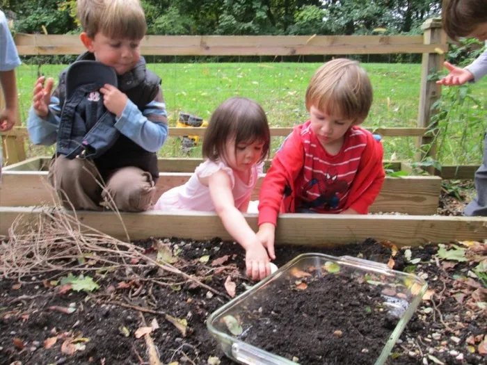 Children tending the raised garden beds together