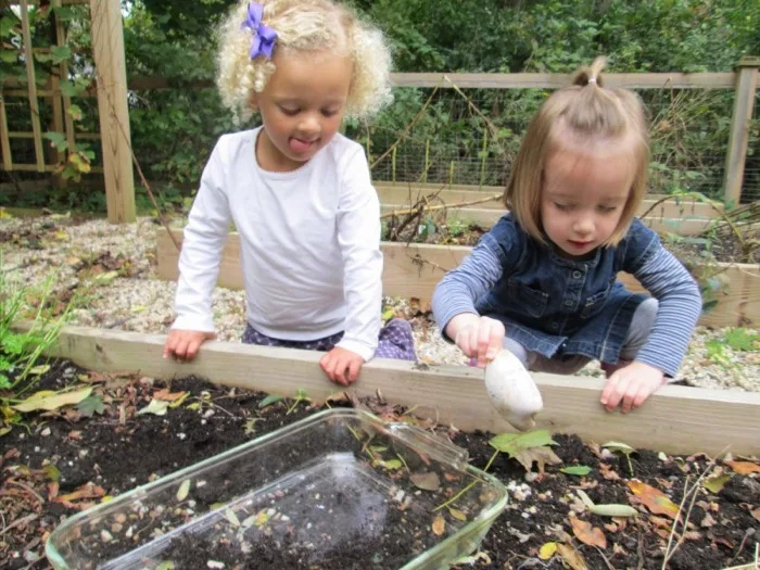 Two girls working together in the vegetable garden